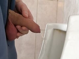 A guy pisses in a public urinal from an uncut penis without opening it 4K