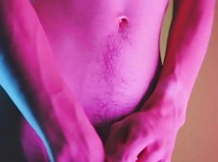 Sensual moves on colored background, showing bulge and hairy soft cock