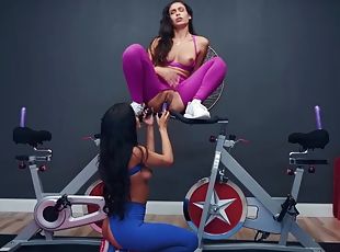 Lesbians in torn workout pants toy fucking in the gym